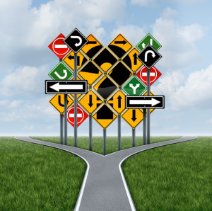 Confusing direction decision questions deciding on a clear strategy for solutions in business with a crossroads path to success choosing the right strategic plan with the challenge of a group of confusing traffic signs as a guide.