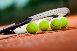 Close up view of tennis racquet and balls