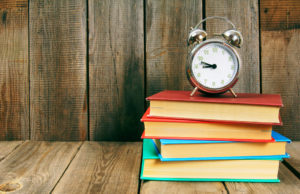Back to school. Books and an alarm clock.